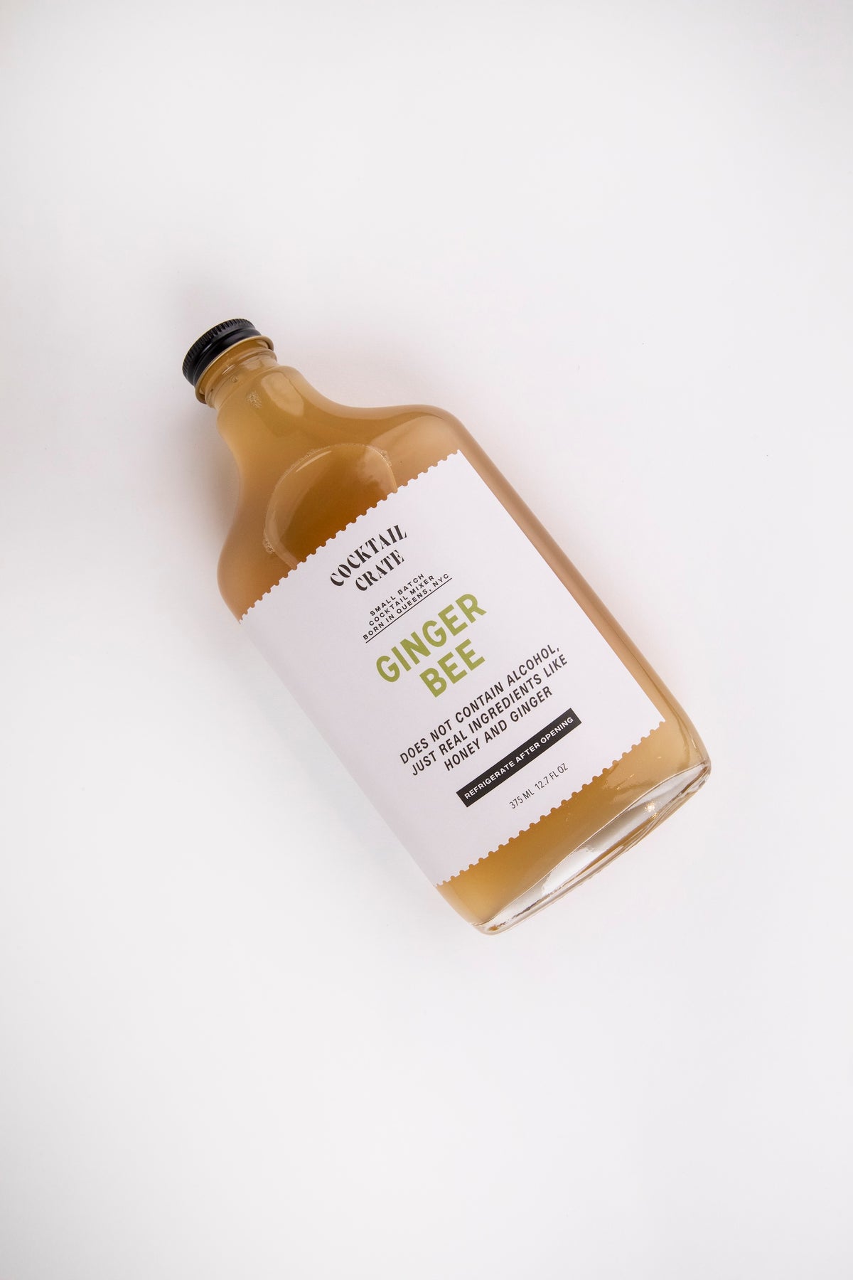 Cocktail Crate Ginger Bee mixer bottle lying on a white backdrop