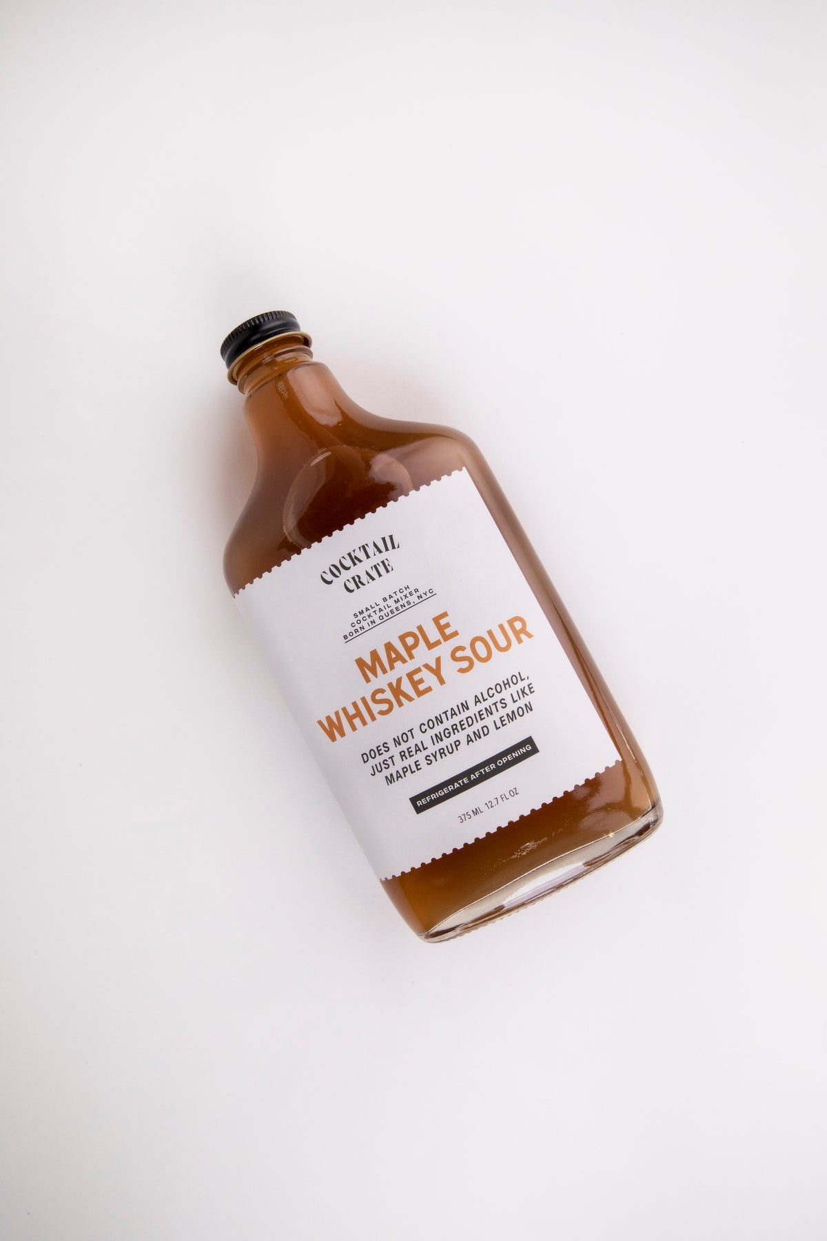 Cocktail Crate Maple Whiskey Sour mixer bottle lying on a white backdrop